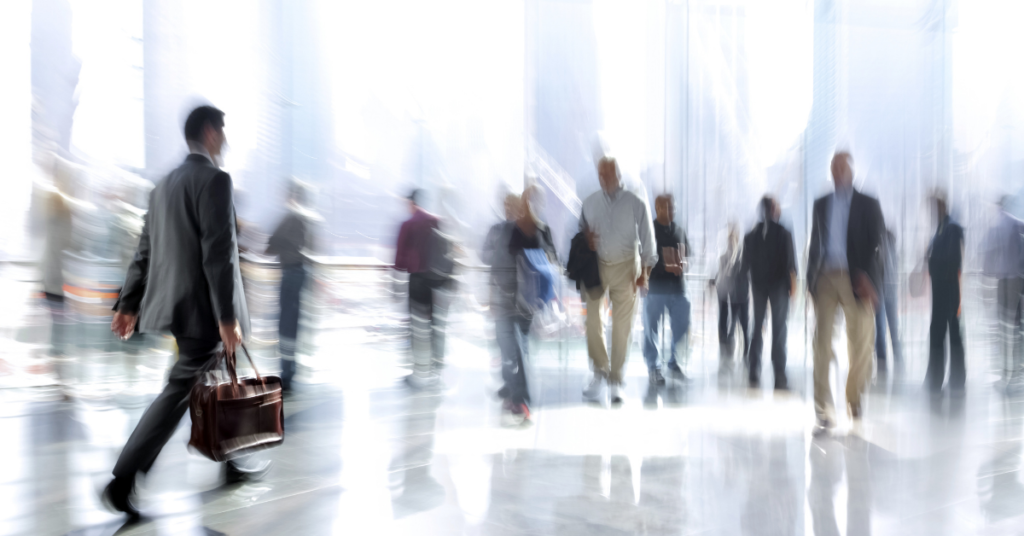 Blurred vision image of businessmen and women walking in a downtown commercial area